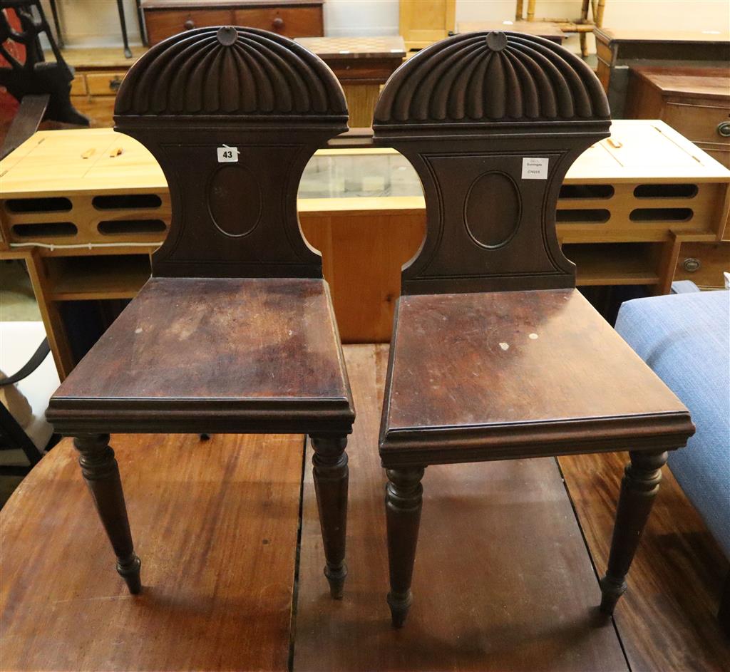 A pair of George III mahogany hall chairs